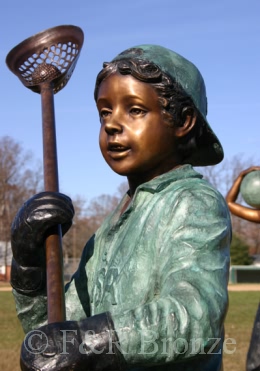 Boy Playing LaCrosse bronze sculpture
