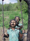 Kids Swinging bronze statue