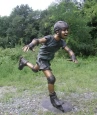 Boy Rollerblading bronze statue
