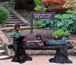Boy and Girl Reading on Log Bench Bronze Statue