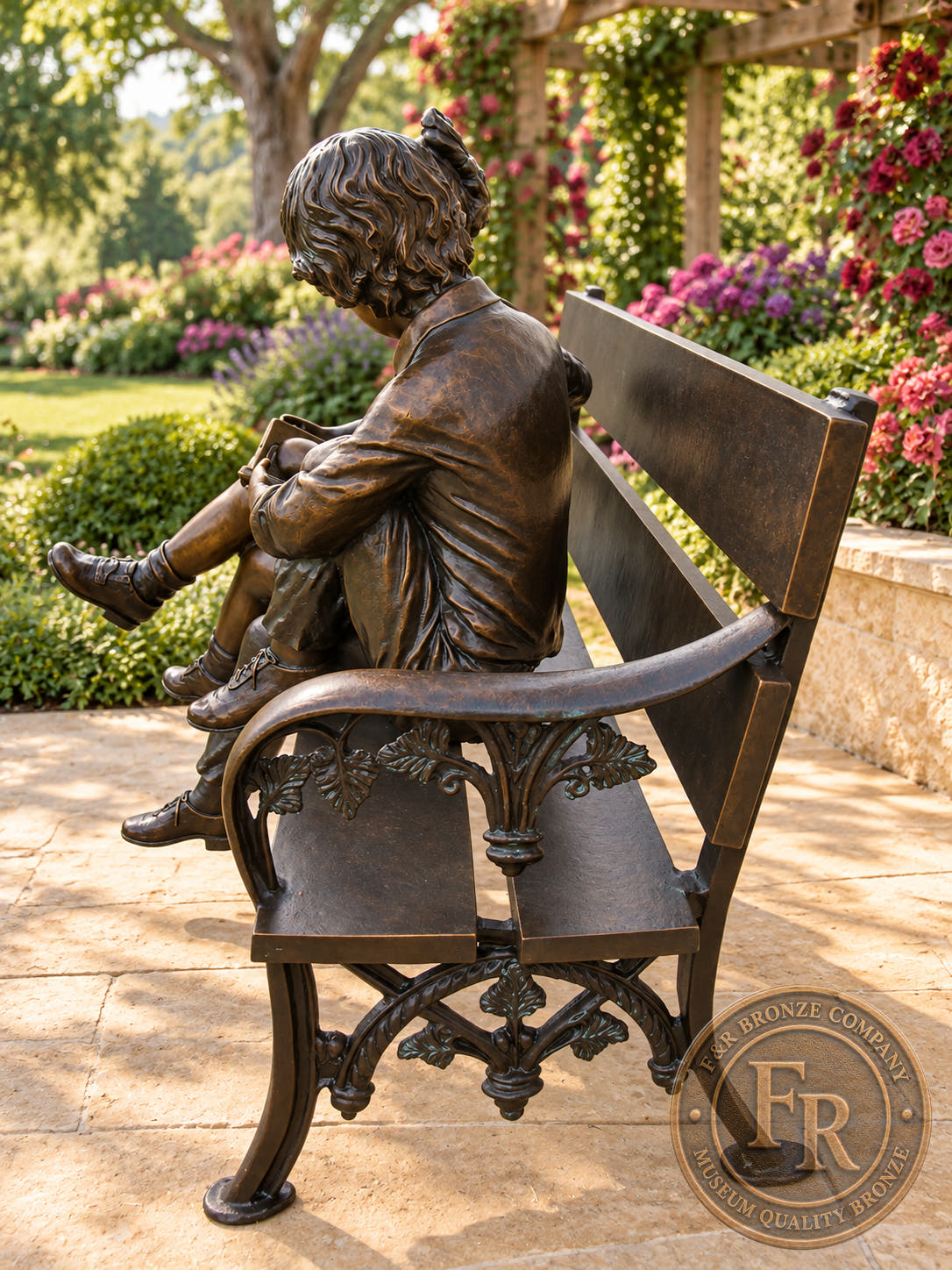 Rear three-quarter garden concept of the brown bronze reading bench, showing the children’s backs and ornate arm support.