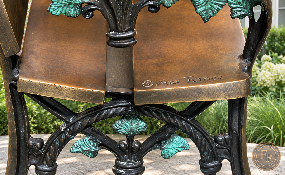 Architectural concept detail of the bronze bench end, with warm brown metal and turquoise leaf ornament in a library garden.