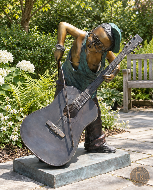 Jumbo Boy Playing Guitar Bronze Statue, item 806, front three quarter, in a modest garden setting. Placement concept based on the owner-supplied product photograph.