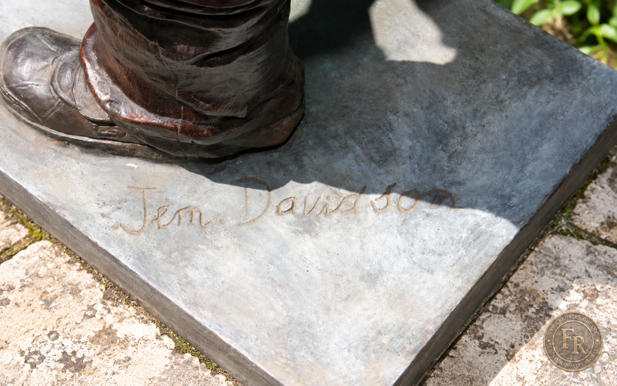 Jumbo Boy Playing Guitar Bronze Statue, item 806, original base and signature detail, in a modest garden setting. Placement concept based on the owner-supplied product photograph.