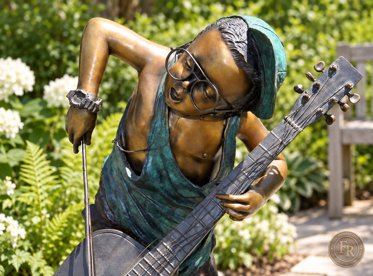 Jumbo Boy Playing Guitar Bronze Statue, item 806, upper front detail, in a modest garden setting. Placement concept based on the owner-supplied product photograph.