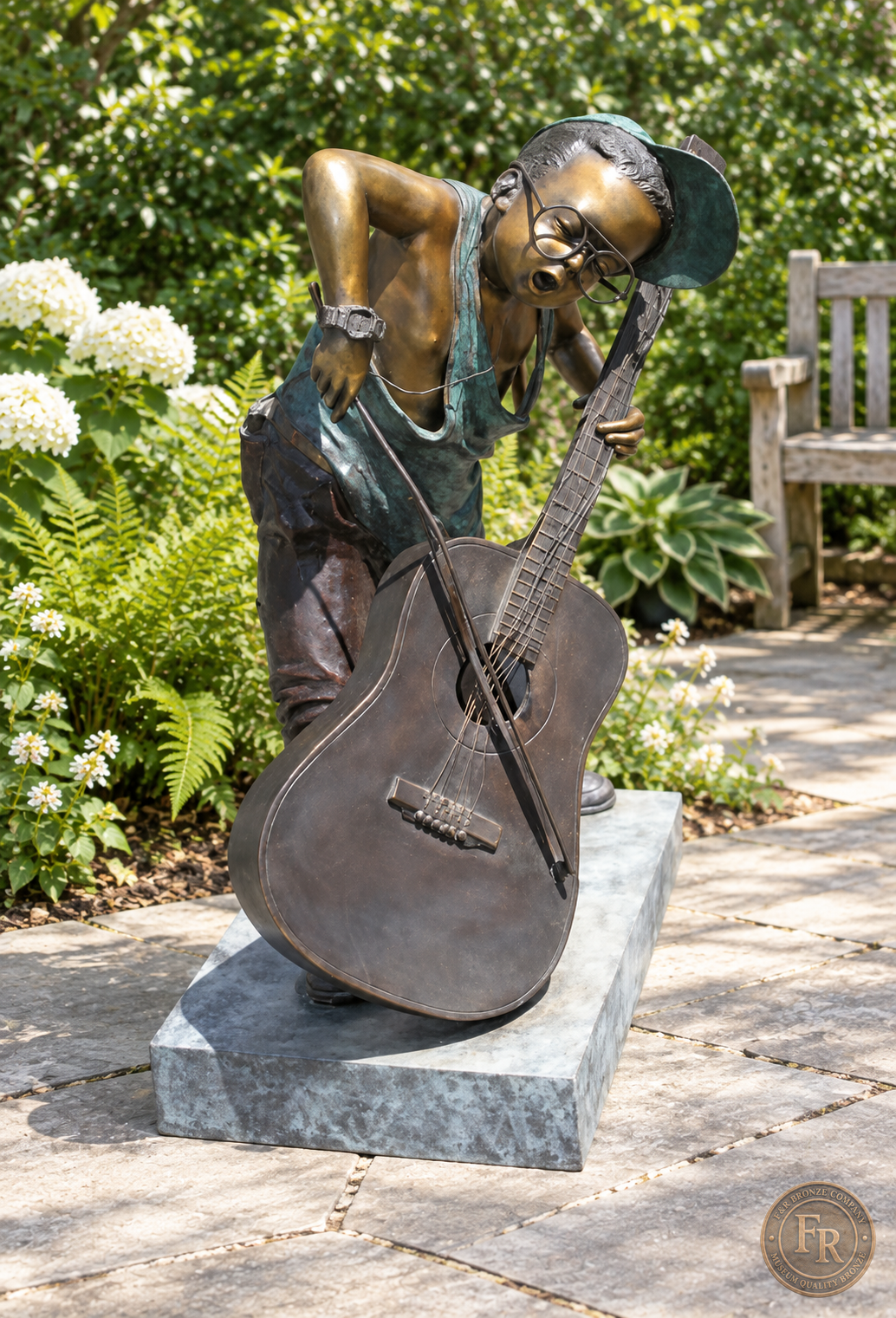 Jumbo Boy Playing Guitar Bronze Statue, item 806, front alternate, in a modest garden setting. Placement concept based on the owner-supplied product photograph.