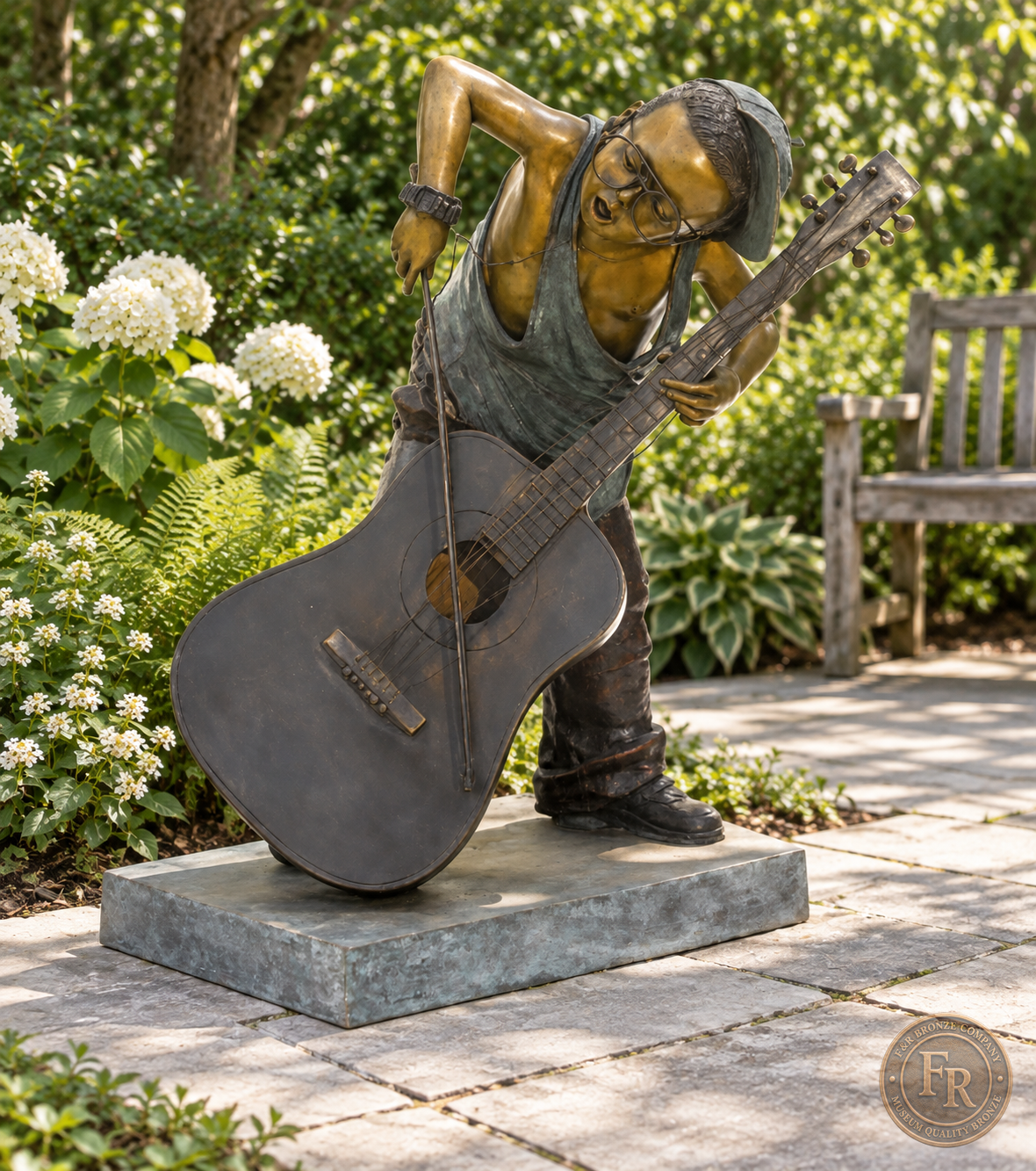 Jumbo Boy Playing Guitar Bronze Statue, item 806, front studio angle, in a modest garden setting. Placement concept based on the owner-supplied product photograph.