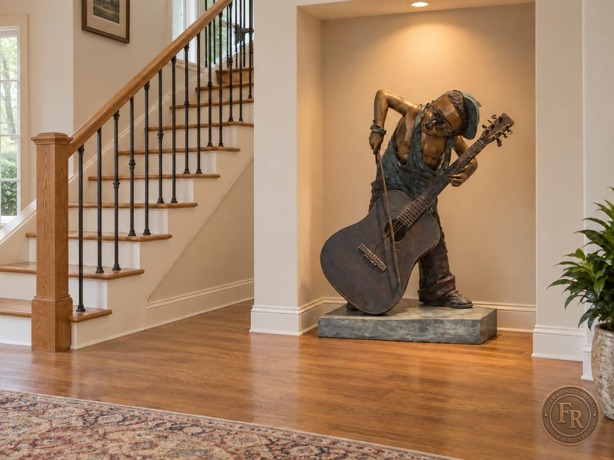 Boy musician bronze sculpture, alternate front view, placed in a wall display recess beside stairs with its original base and clear walking space.