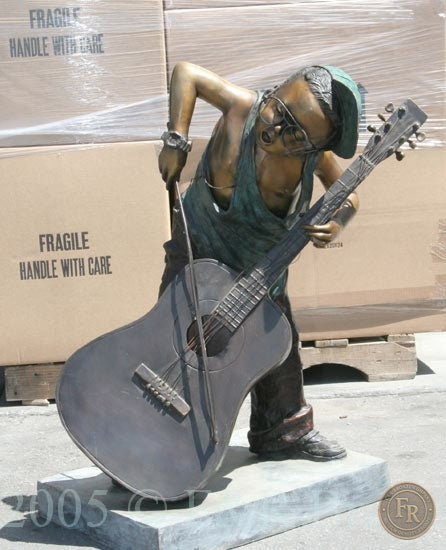 Original front three-quarter photograph of Jumbo Boy Playing Guitar Bronze Statue, item 806, F&R Bronze.