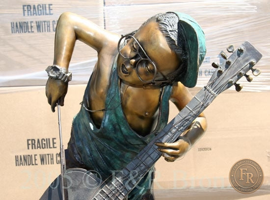 Original upper front photograph of Jumbo Boy Playing Guitar Bronze Statue, item 806, F&R Bronze.