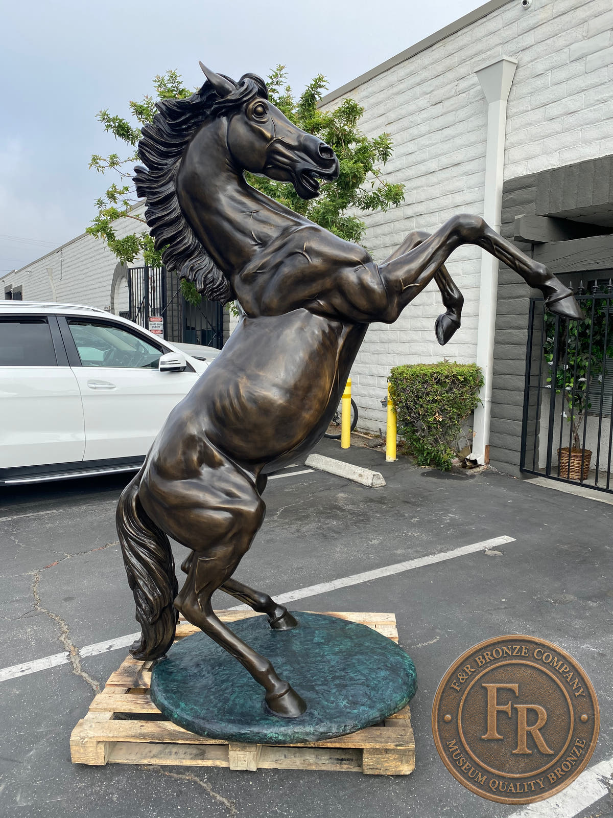 Opposite side of the Left stallion bronze sculpture, showing the mane and curved tail.
