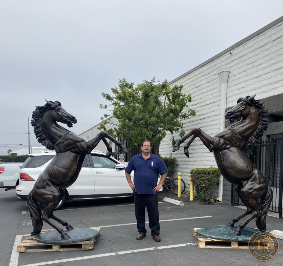 Front product photograph of the Right and Left stallion bronze statues on their oval green bases.