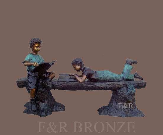 Front view of the Reading Time children bronze statue, showing two readers, the textured log and stump supports against a brown background.