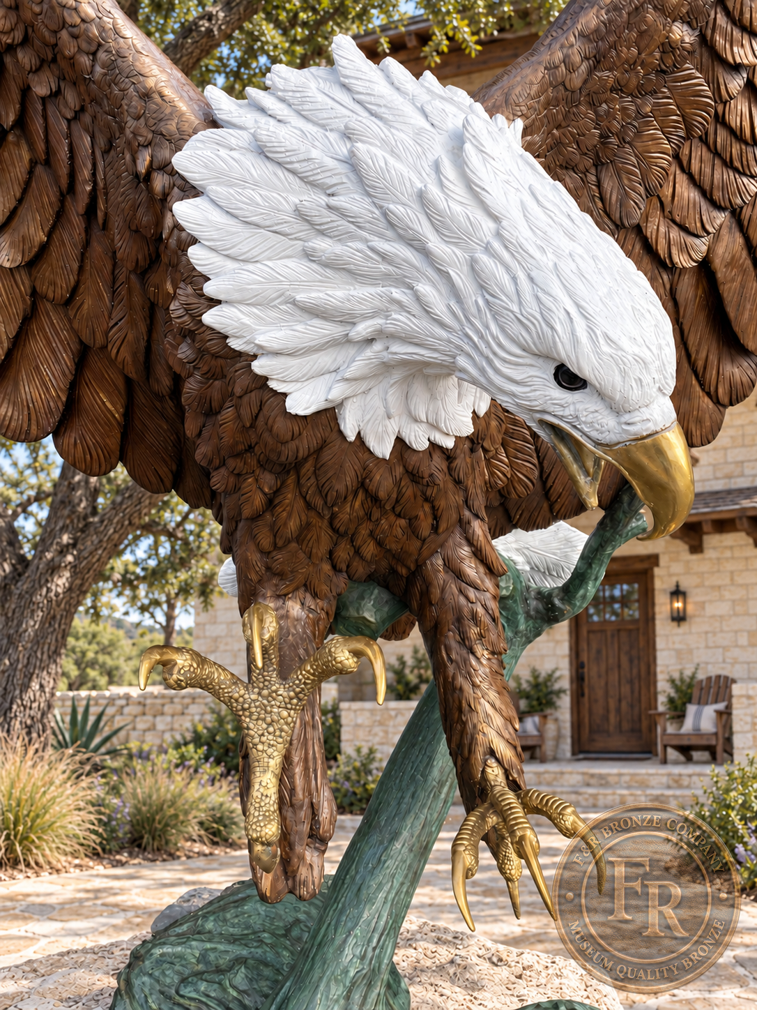 Close-up of the bronze bald eagle statue, showing white head feathers, a hooked gold-colored beak and both extended talons.