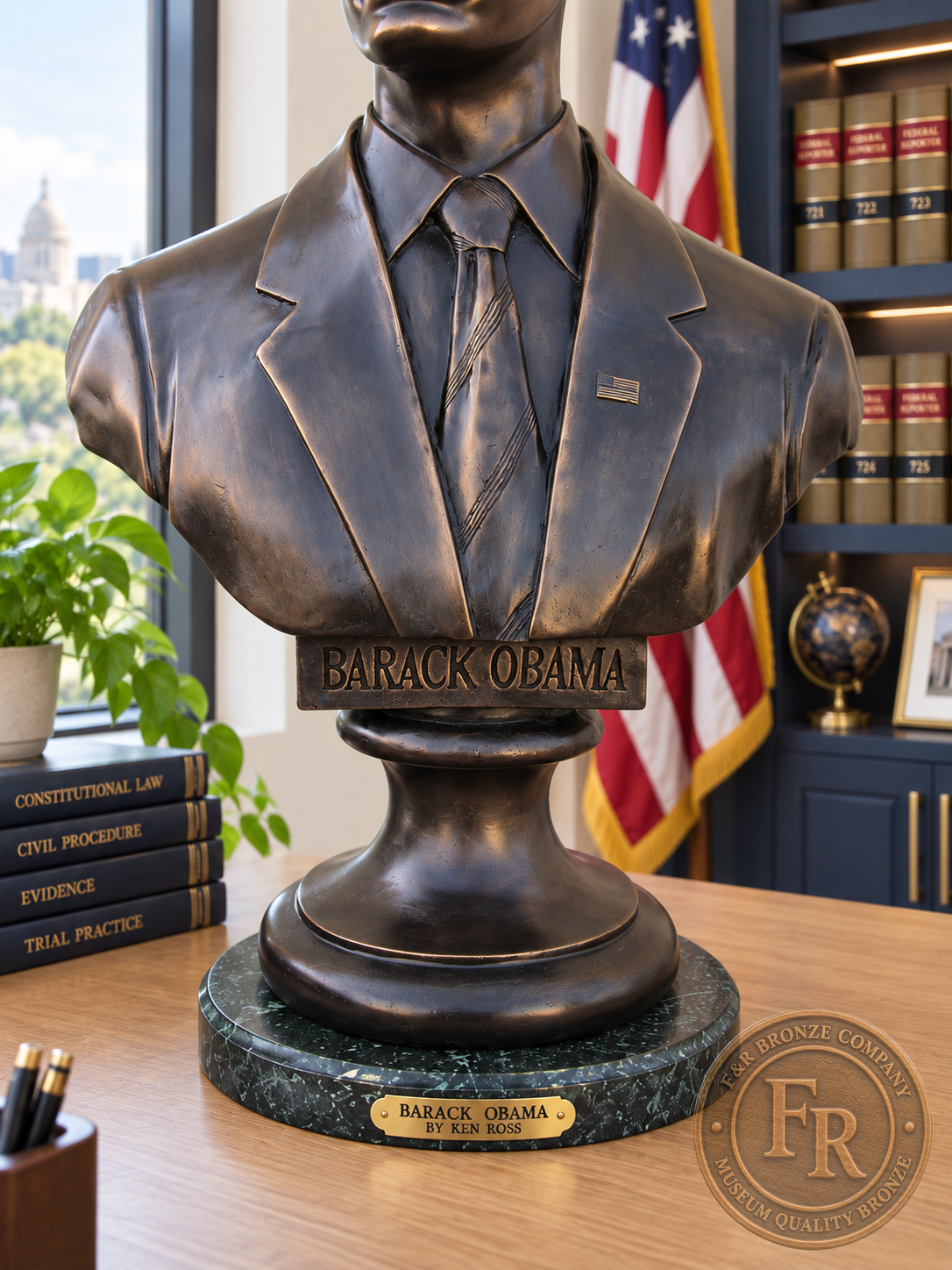Barack Obama bronze bust pedestal detail, showing the nameplate, suit jacket and circular green stone base.