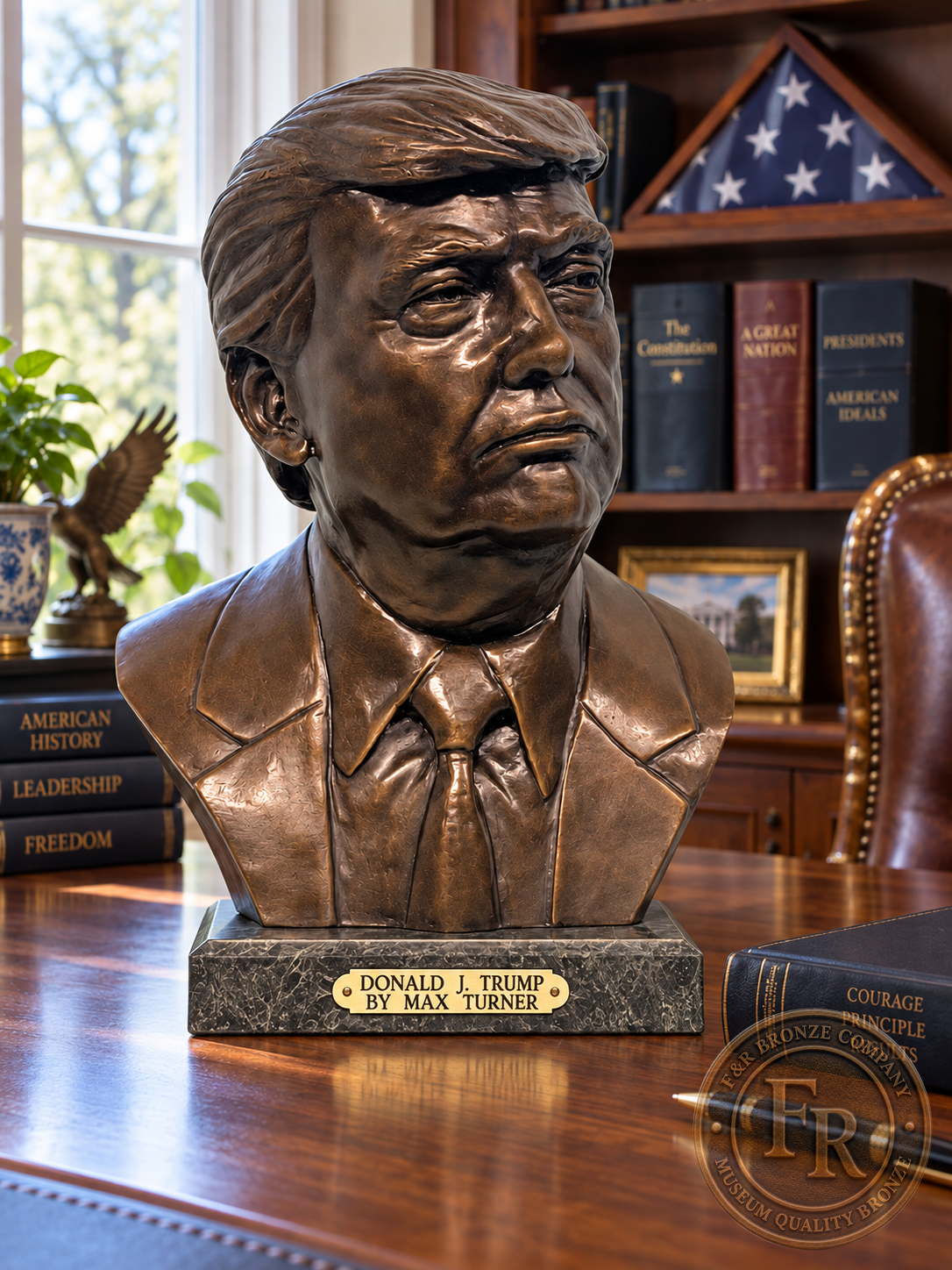 President Donald J. Trump bronze bust by Max Turner, front three-quarter view on a walnut office desk with a stone base.