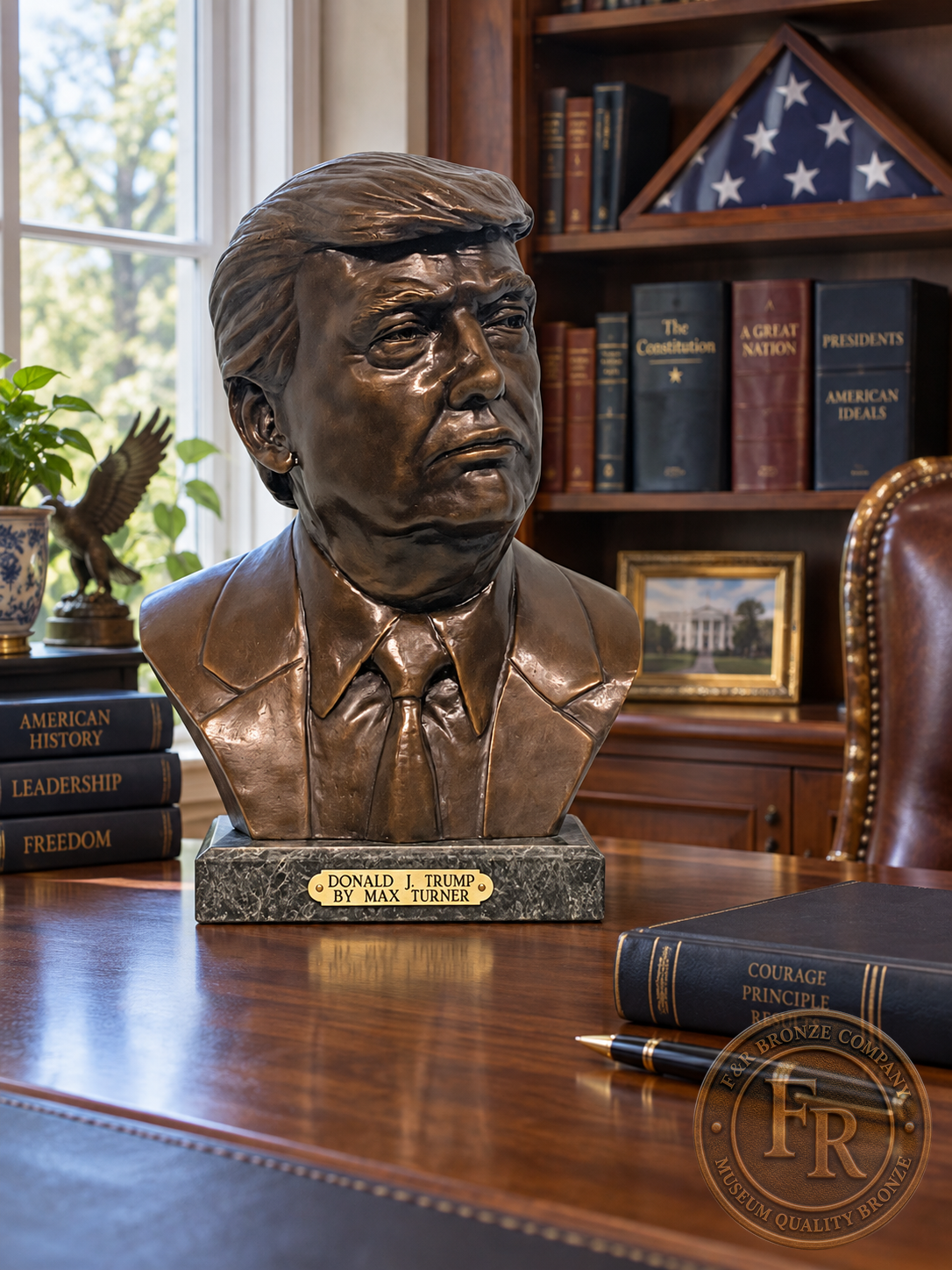 Donald J. Trump bronze statue in a wide office view, displayed on a walnut desk near books and a folded American flag.