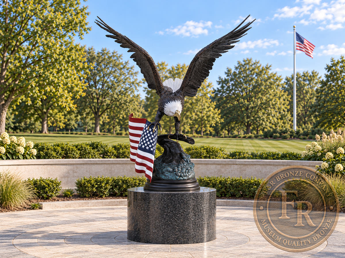 Front view of the monumental eagle bronze statue with painted white head and flag in a veterans memorial concept.