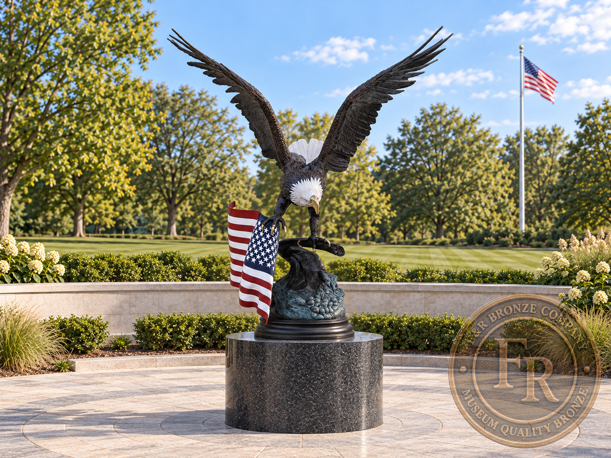 Front view of the monumental eagle bronze statue with painted white head and flag in a veterans memorial concept.