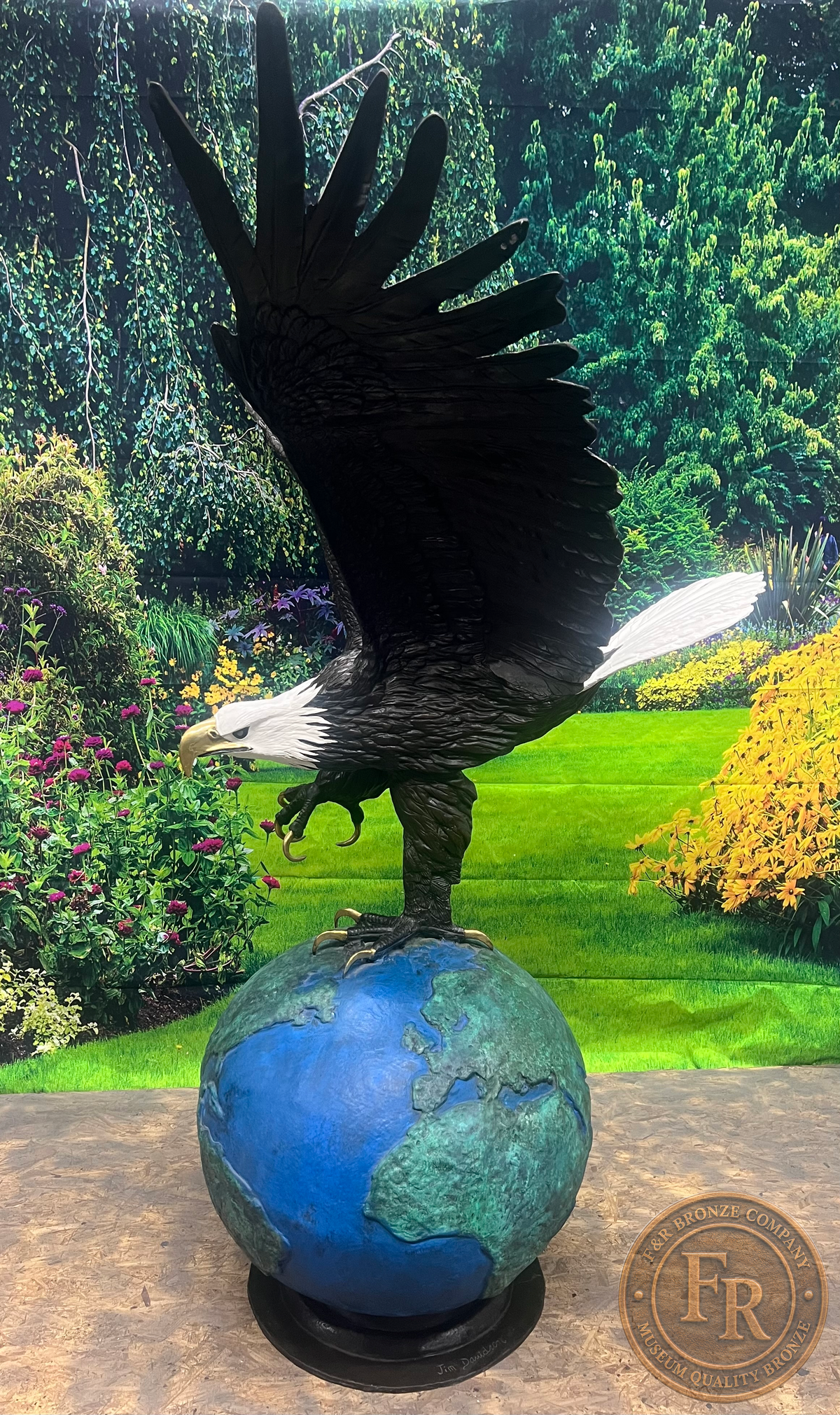 Original left-side photograph of the eagle on globe bronze statue, showing its raised wing, profile and round bronze base.
