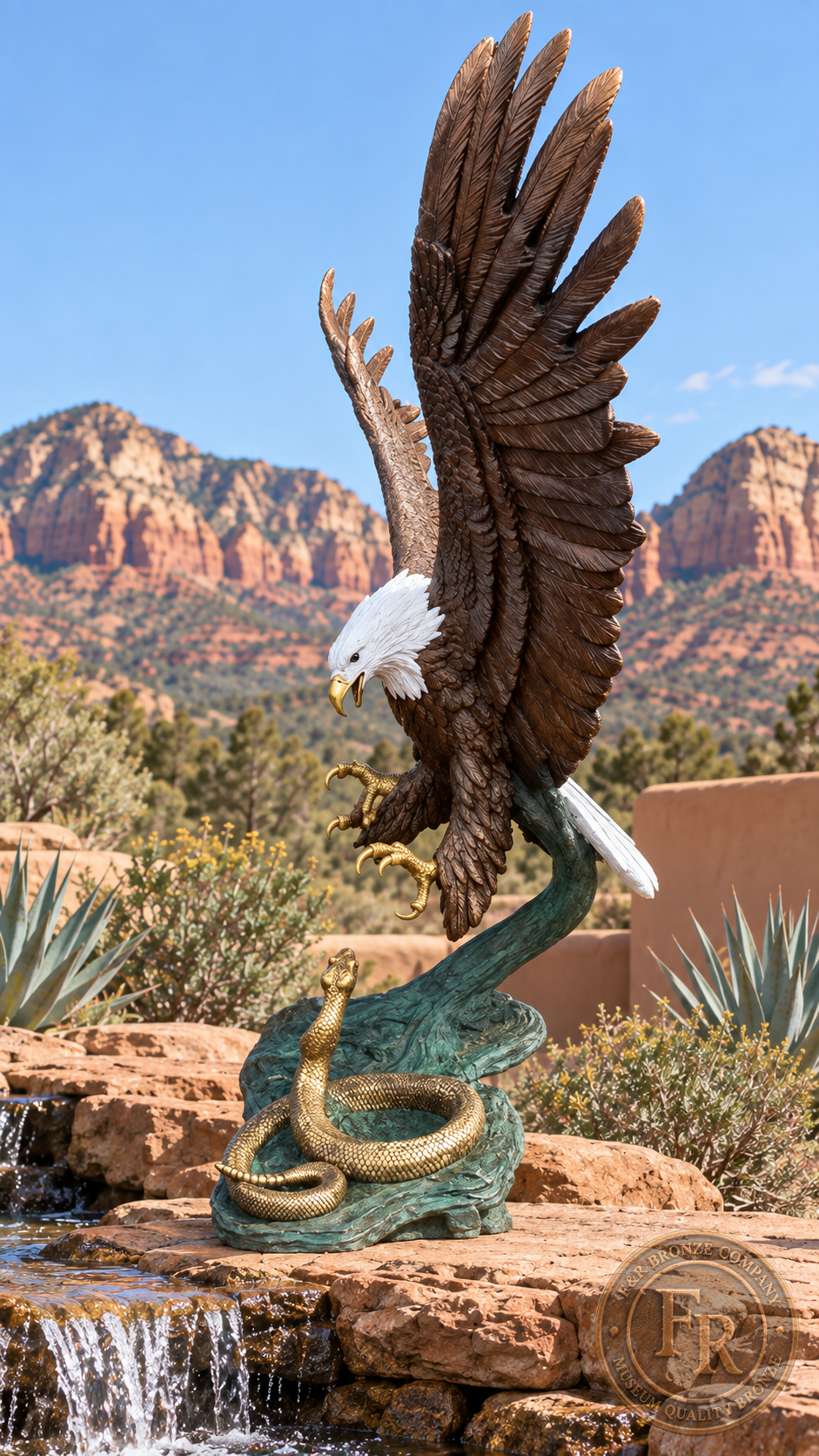 Side profile of the eagle with snake bronze sculpture beside a waterfall, showing its upright wings, reaching talons and green base.