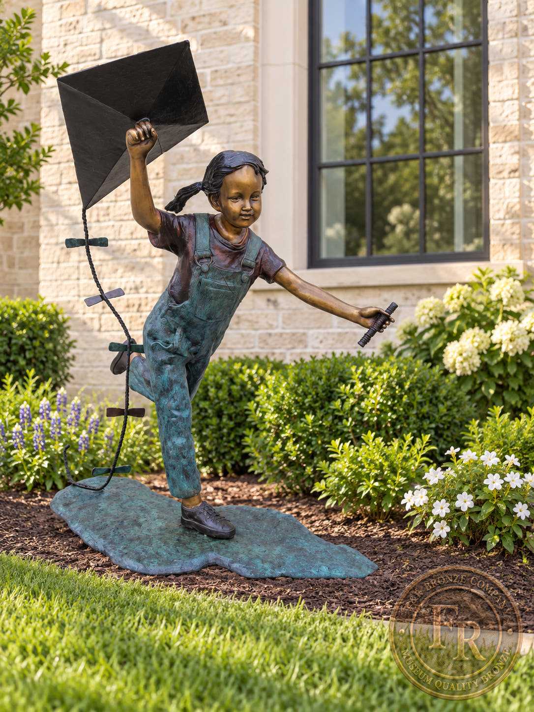 Girl Flying Kite bronze statue, full front view showing the little girl’s running pose in an architectural garden concept.