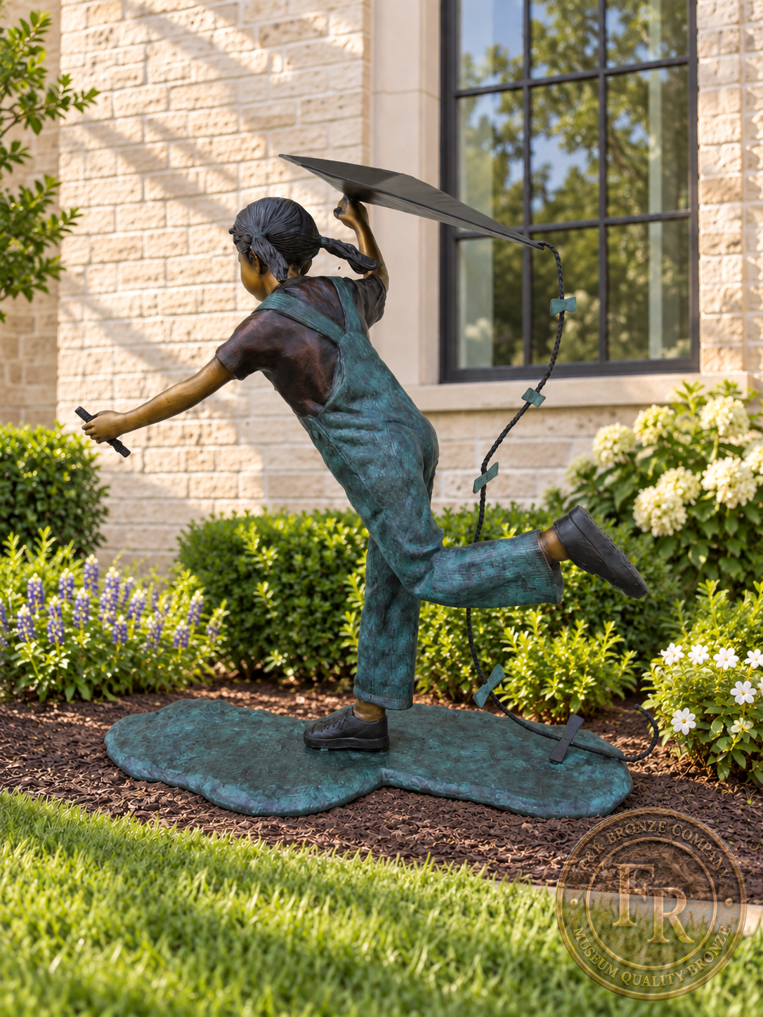 Side view of the little girl running with a kite bronze statue, showing her extended arm, overalls and lifted foot.