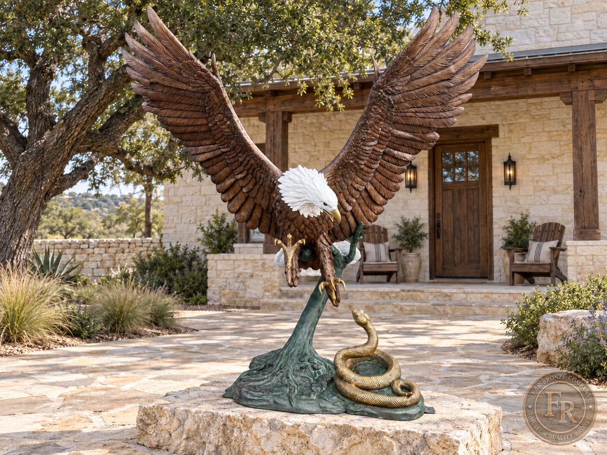 Full front view of the heroic eagle with snake bronze sculpture on a stone slab in an estate courtyard, with its complete base visible.