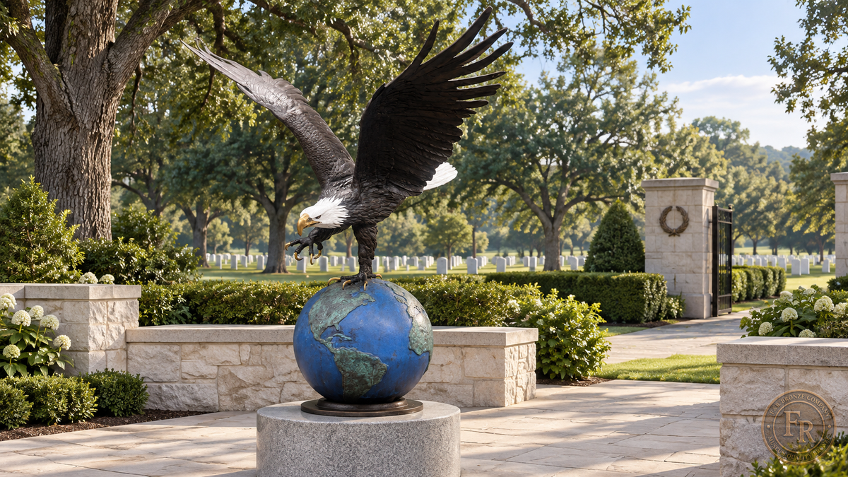 Architectural concept: monumental bronze eagle on a world globe in a landscaped cemetery memorial setting.