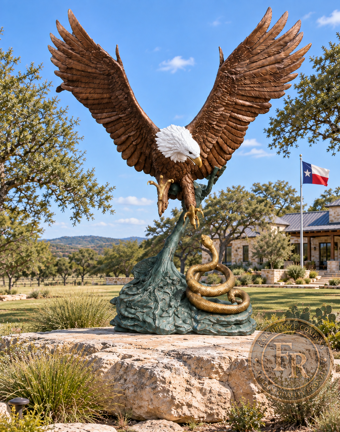 Front view of the outdoor eagle and rattlesnake bronze statue on a rock platform, with a ranch house and Texas flag behind it.
