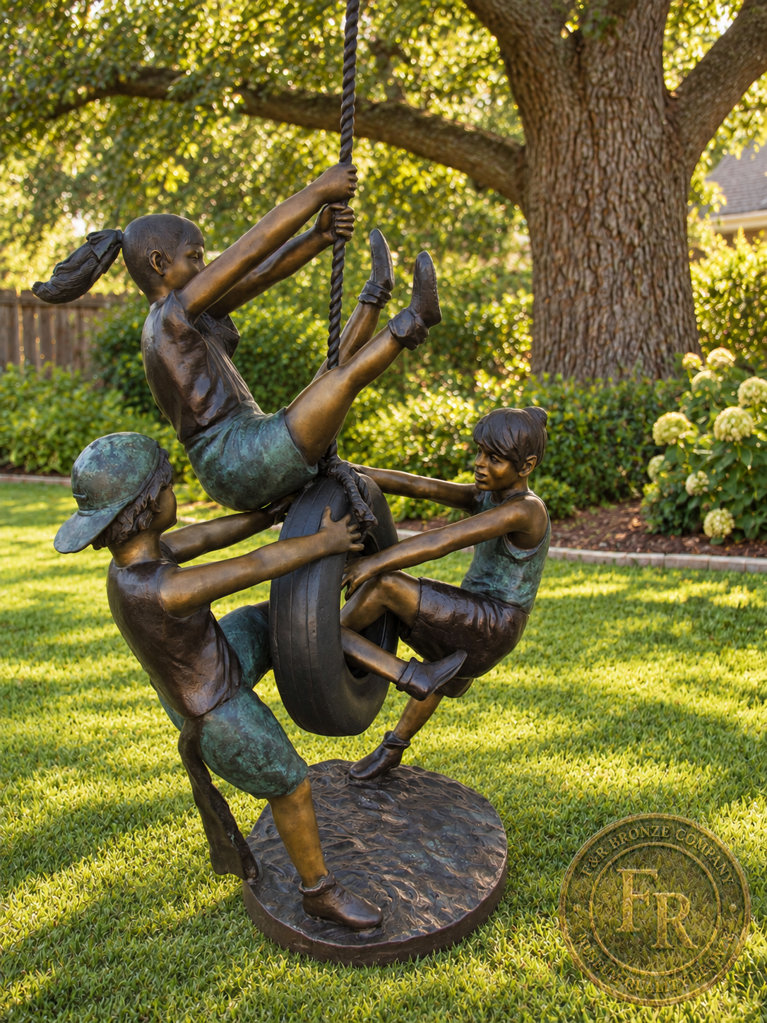 Three-quarter view of the life-size tire swing bronze sculpture, showing the girl and two boys in a landscaped garden concept.