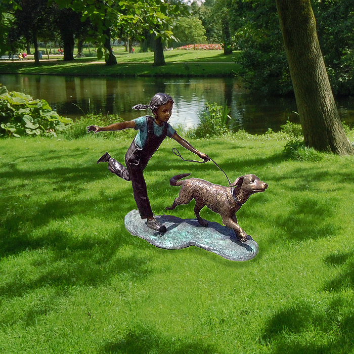 Little girl running with dog sculpture