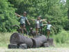 Four Kids on Logs bronze statue