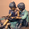 Kids on Bench Reading bronze statue