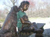 Girl with Dogs on Bench bronze statue