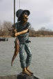 Boy with Fish bronze statue