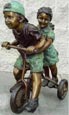 Boy and Girl on Tricycle bronze statue
